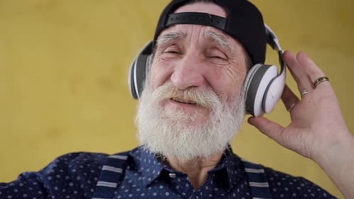 Elderly Man Listening to Music and Dancing