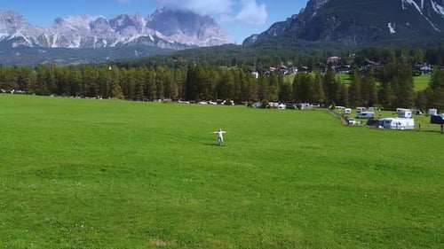 Camera Revolving Around Woman Enjoying the Beauty of Dolomites in the Background