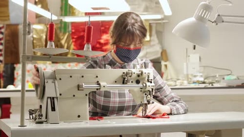 Young Adult Sews Fabric with Vintage Machine