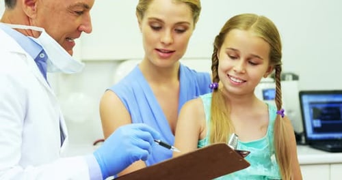 Dentist interacting with young patient