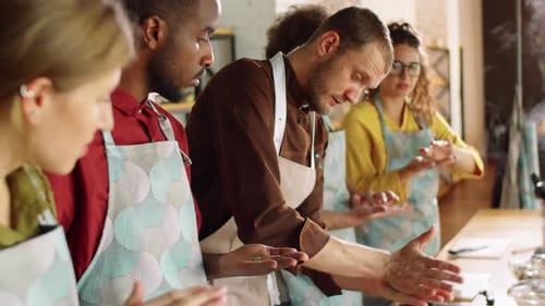 Cooking Class Students Learning Food Preparation in Kitchen