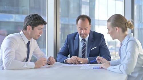 Business Team Reviewing Documents Together at Office