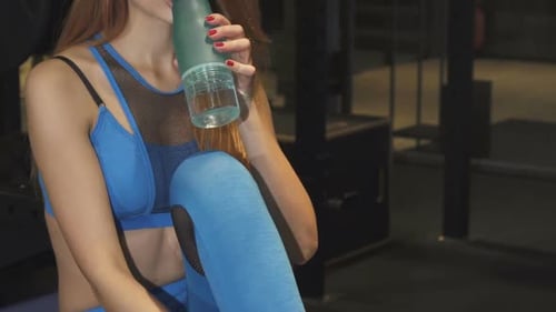 Beautiful Happy Fitness Woman Smiling Drinking Water After Gym Training