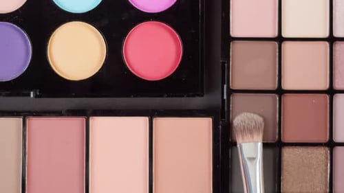 Makeup Brush Applying Eyeshadow on Colorful Palette