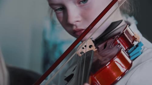 Young Child Plays the Violin