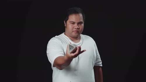 Young Adult Shuffles Deck of Cards