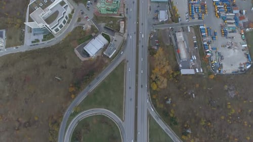 Top View of City Entrance, Cars Driving on Bypass Road. Full Parking Lot at the Side