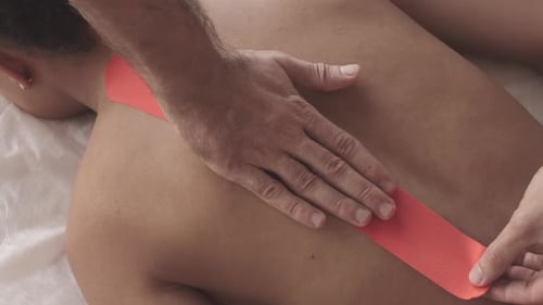 Medical Tape Applied to Woman's Back for Therapy