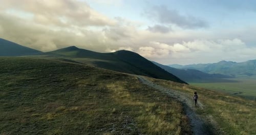 Aerial View Flying Above Hiker Man Hiking or Nordic Walking Outdoor on a Trail Path Near