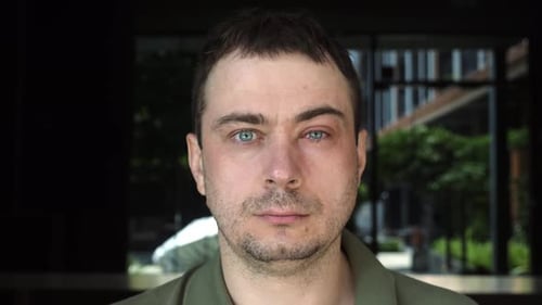 Man with Sick Irritated Red Bloodshot Eye Conjunctivitis Looking at Camera