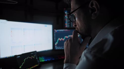 Male Trader Analyzes the Stock Market