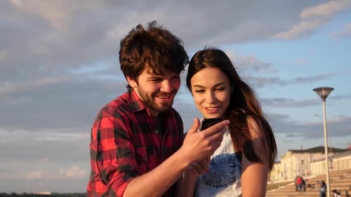 Couple Sharing Smartphone Moment at Urban Promenade