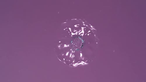 Blue Liquid Dropping and Rippling in Pink