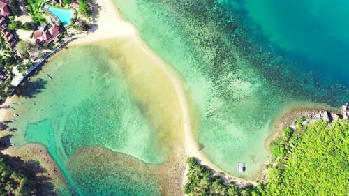 Lagoa pacífica com recifes de coral e rochas sob águas cristalinas calmas perto de um resort de férias em frente a