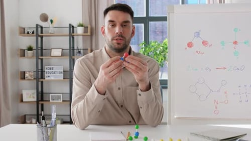 Man Teaching Chemistry with Molecular Models Online