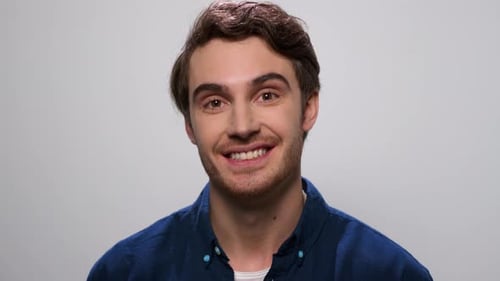 Smiling Young Adult Male in Blue Shirt