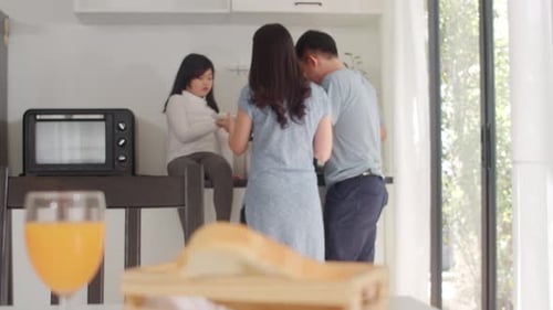 Family Prepares Food Together in Sunny Kitchen
