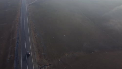 Car On The Highway In The Foggy Morning