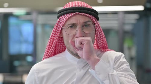 Man Coughing in an Office