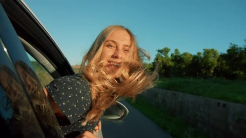 Woman Enjoying Wind in Hair During Car Ride