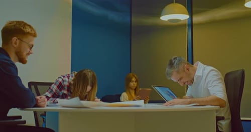 Colleagues at a Meeting of the Company's Sales Department Discussing Issues