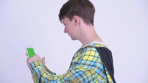 Rear View of Young Handsome Man Using Phone