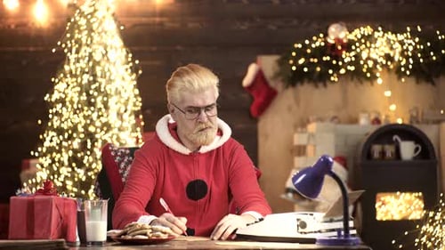 Man Writing Letter in Decorated Christmas Room
