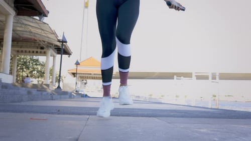 Woman Exercising with Jump Rope in Urban Setting