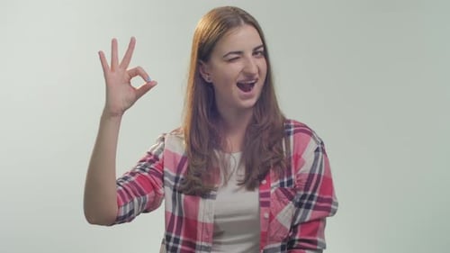 Woman Giving Okay Sign and Winking