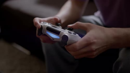 Person Playing Video Game with Controller Close Up
