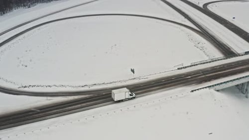 Delivery Van Rides a Bridge. Car Driving on Winter Country Road, Aerial View From Drone in