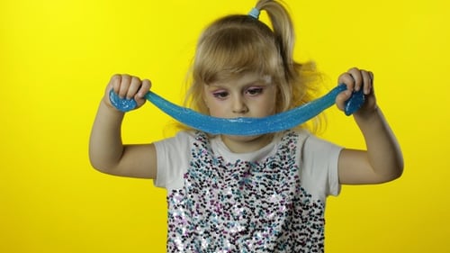 Kid Playing with Hand Made Toy Slime. Child Having Fun Making Turquoise Slime. Preschool Girl