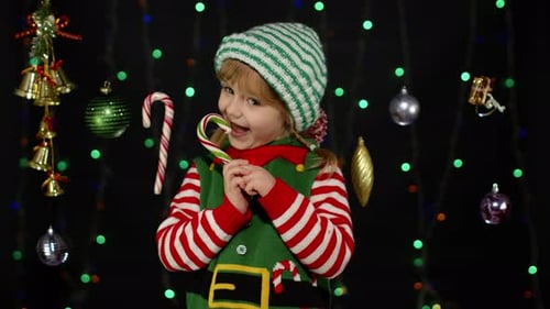 Girl in Elf Costume Holding Candy Cane