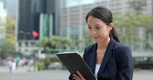 Business Woman Uses Tablet in City Square