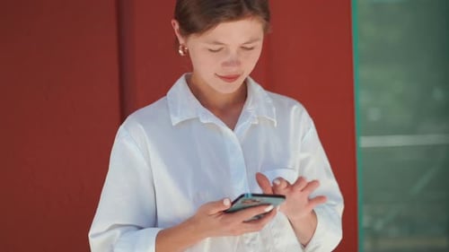 Excited Caucasian Businesswoman Standing Near Office Building and Feeling Surprised While Looking on
