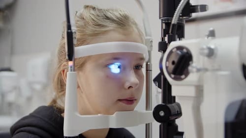 Young Girl at the Reception of an Ophthalmologist Checks Eyesight
