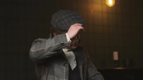 Stylish Young Man Removes Cap Indoors