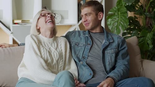 Senior Woman and Young Man Laughing Together