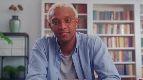 Handsome African American Man Smiling Charmingly at Desk in Living Room
