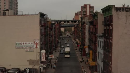 Low Flight Through Chinatown, New York City Street with Chinese Asian Letters Towards Bridge