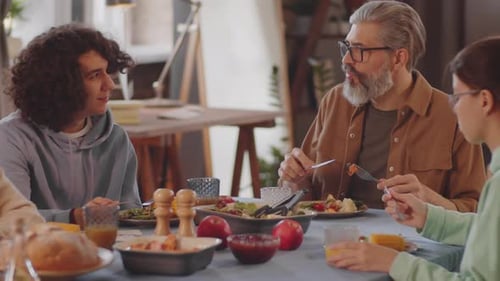 Family Meal with Conversation Around a Table