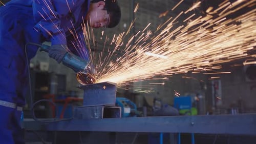 Worker Grinding Metal with Shower of Golden Sparks
