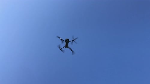 Drone Flies Against Pure Blue Sky
