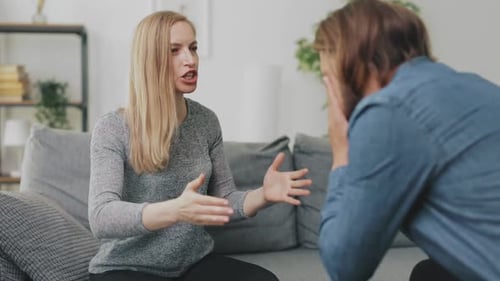 Woman Arguing with Man on Couch