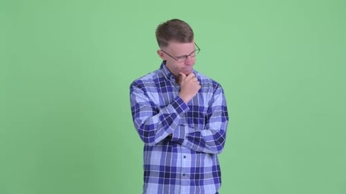 Man with Glasses Standing Still and Thinking