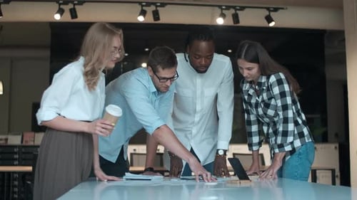 Diverse Team Collaborating on Project in Office