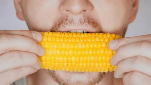 Close Up Face Fair Man Eats Corn