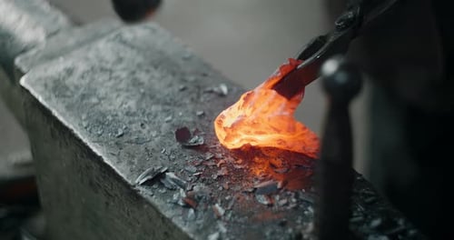 Blacksmith Working Red Hot Metal on Anvil