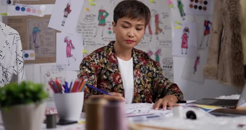 Fashion Designer Working at Desk Drawing
