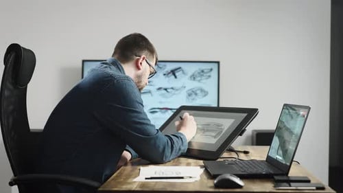 Car Designer Working on Tablet in Office
